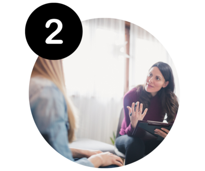 Woman speaking with professional with note pad